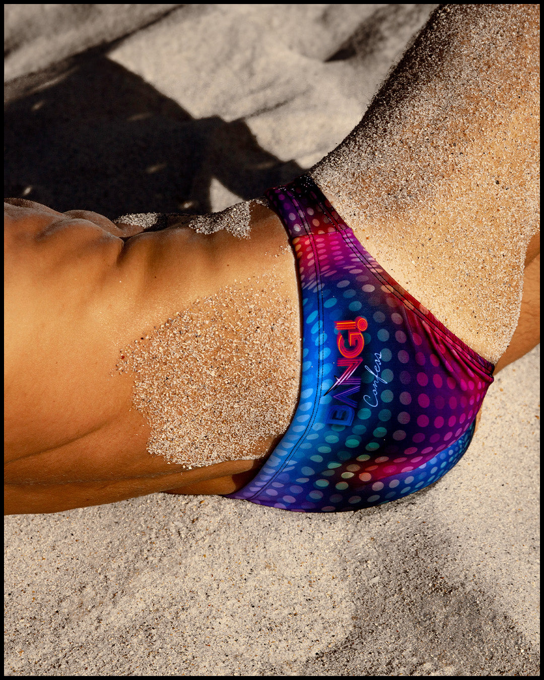 Male model wearing the CONFESSIONS ON A SAND FLOOR Tank Top featuring multiple colors disco ball print by BANG! Clothes the official brand of men’s swimwear brand based in Miami, FL.