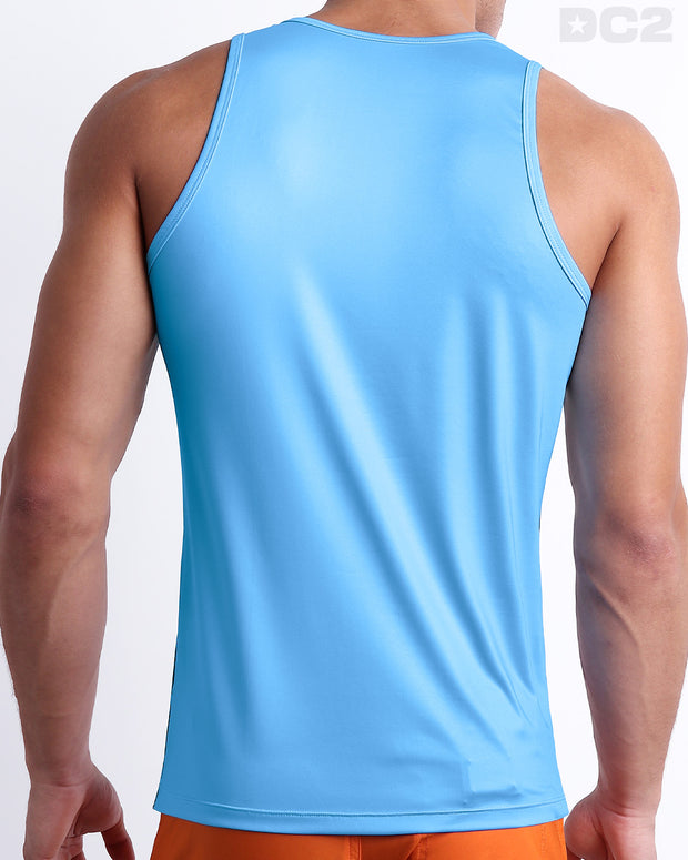 Male model wearing men’s COASTAL BLUE men’s Summer Tank Top in sky blue color with stylish navy and orange colored stripes. This high-quality shirt is by DC2, a men’s beachwear brand from Miami.