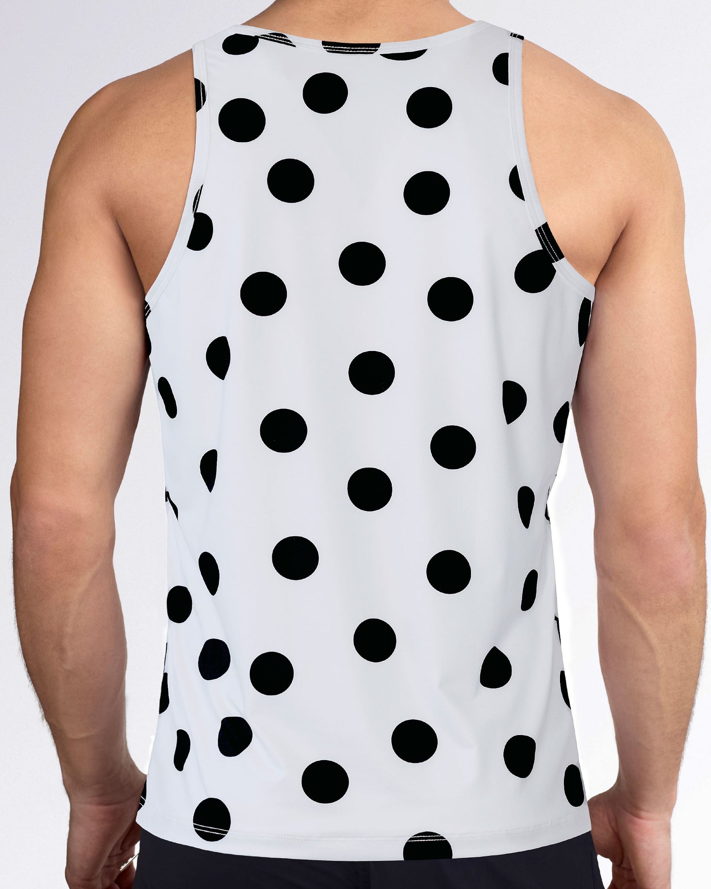 Men’s workout tank top with racerback-style cut, allover black dot print, white performance fabric, and sleeveless fit.