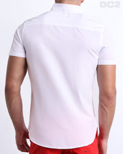 Back view of a male model wearing a FORZA WHITE men’s Hawaiian shirt featuring a white color. This high-quality shirt is by DC2, a men’s beachwear brand from Miami.