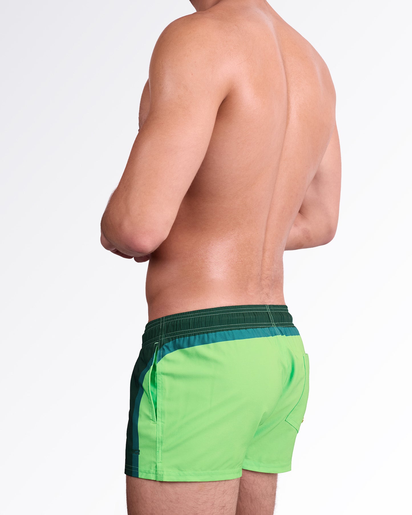 BANG Lines in Stereo Show Shorts — angled back view emphasizing the bold color transition and structured side panel design for a modern resort look.