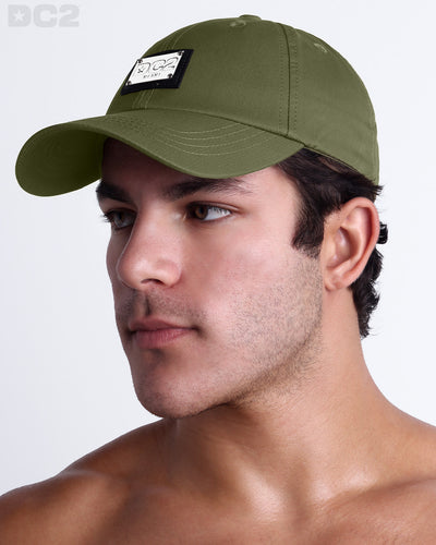 Side view of the Chillax Cap in MAGNUM GREEN,  a dark green color, features ventilation eyelets on the cap to provide extra breathability, perfect for active wear.