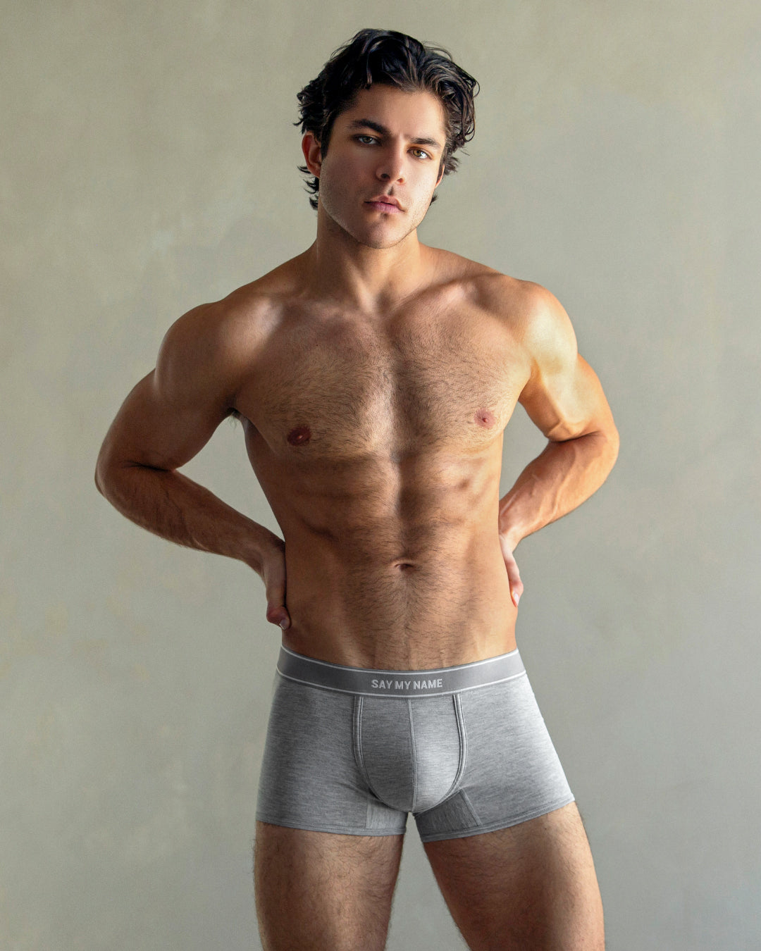 DC2 SAY MY NAME Boxer Brief — male model in studio wearing grey men’s modal boxer briefs with logo waistband, hands on hips, showing athletic fit and contoured pouch.