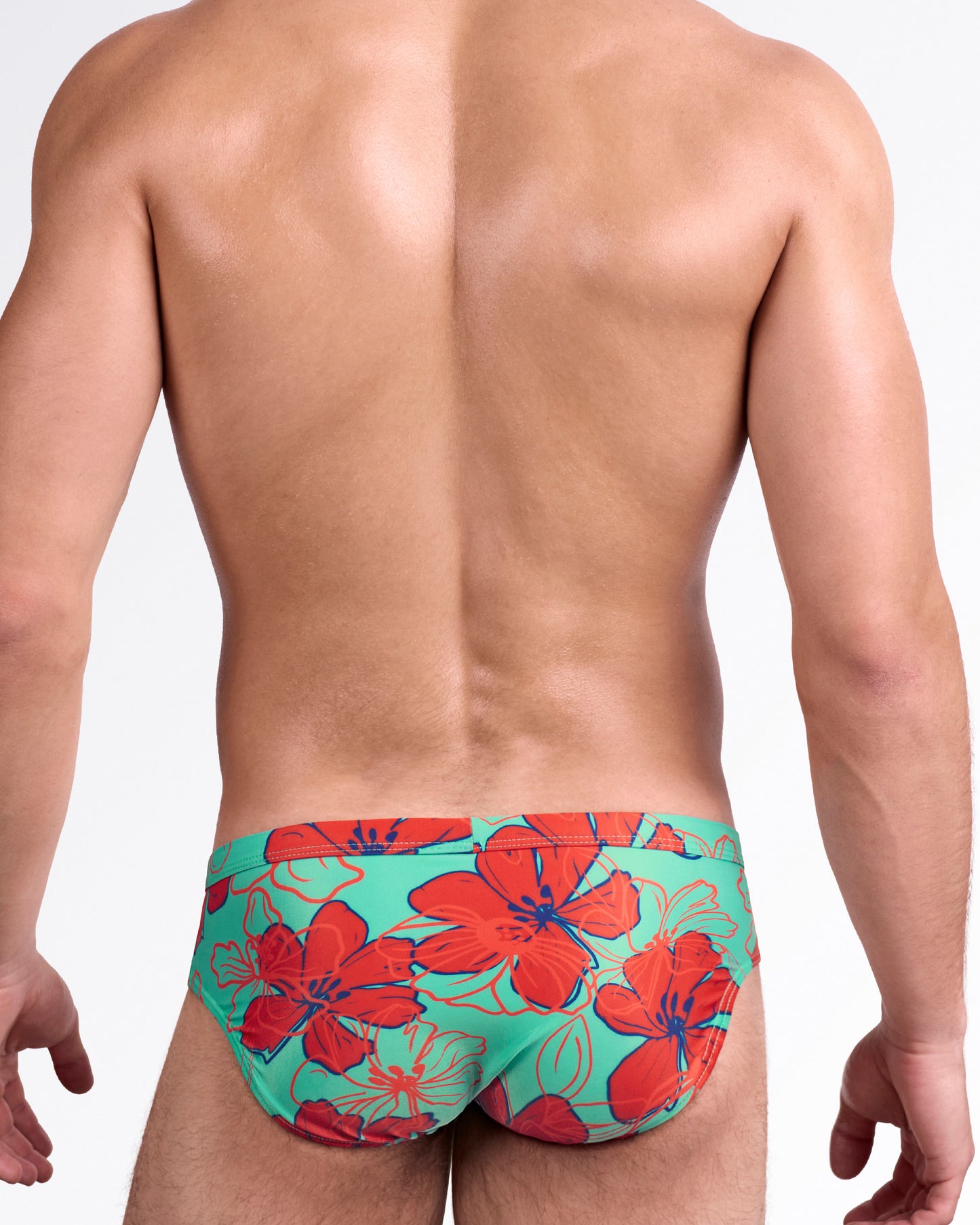 BANG Surf Flowers Aqua Red Swim Brief — back view highlighting full-coverage rear with bold tropical flower pattern in red and teal tones.