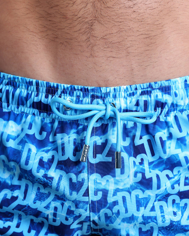Close-up view of the WET men’s summer shorts, showing light blue cord with custom branded silver cord ends, and matching custom eyelet trims in silver.