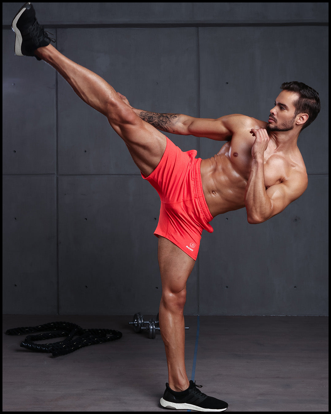 Frontal view of BANG!'s men's orange Jogger Shorts in the style of classic men’s running shorts for workout, fitness or bodybuilding.