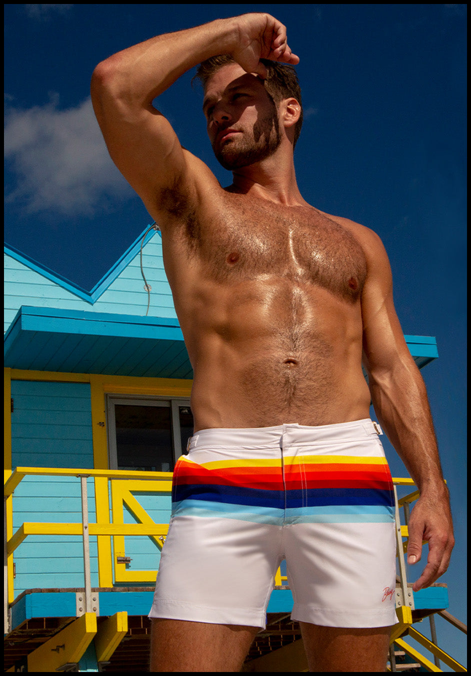 Male model wearing the STRIPES ON 45 men's beach tailored shorts by the Bang! Clothes brand of men's swimwear from Miami.
