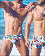 two sexy male models at the beach wearing designer quality premium Bang Miami swim briefs with bold colors and comic prints