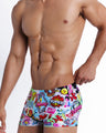 Right side view of an in-shape men's torso wearing a sexy swimsuit featuring cool graffiti print in bold colors with a prominent BANG! sign.