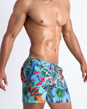 Side view of a men's torso showing the DISCO JUNGLE swim trunks for men in colorful jungle graphic by the Bang! brand of menswear from Miami.
