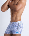 Left side view of men’s Summer swimsuit in blue and white water strokes made by Miami based Bang brand of men's beachwear