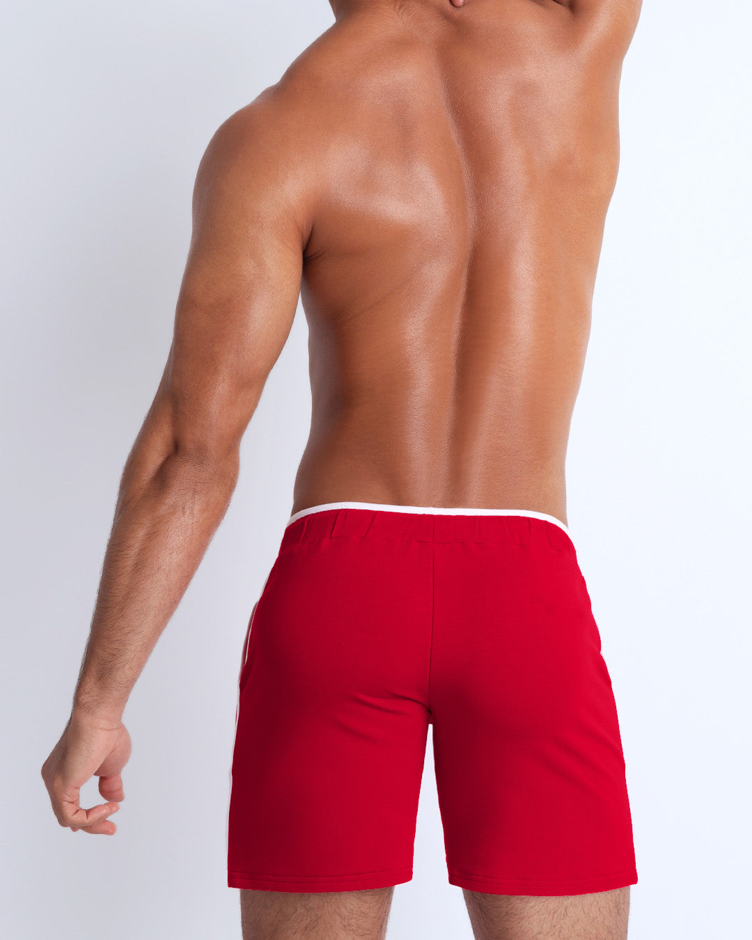 Back view of the men's above-knees length fitness workout shorts in a bright red color by BANG! menswear Miami.