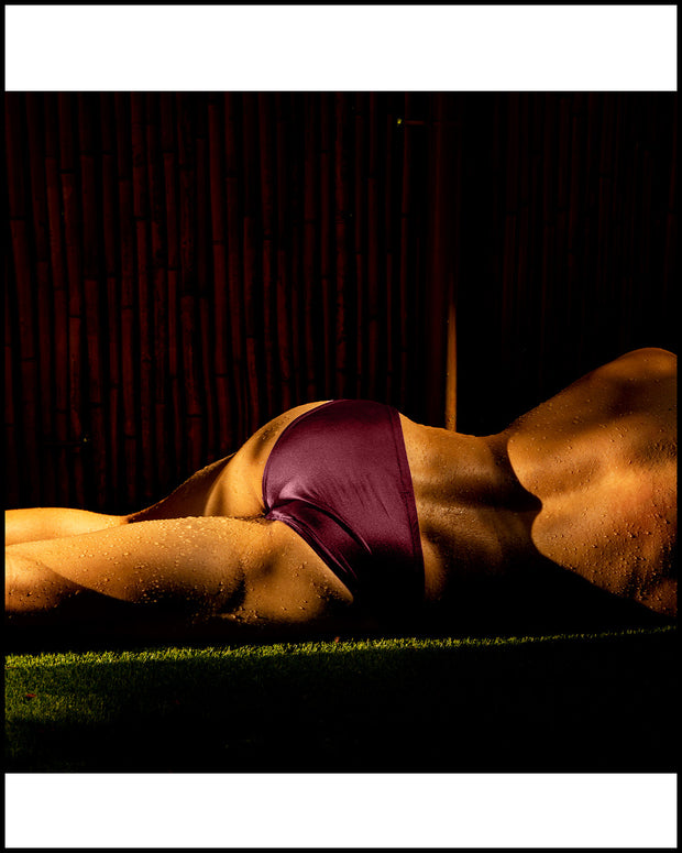 Male model wearing the VERY BERRY Swim Mini Brief a solid berry red wine color by BANG! Clothes