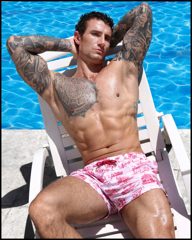 Male model by the pool wearing TOILE DE MIAMI (Red) Show Shorts by BANG! Clothes, showcasing stylish beachwear.