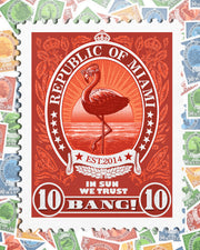 Close-up view of the VIA POSTAL men’s postal stamp image. BANG! Clothes postage stamp inspired by Miami Beach showing a flamingo wearing headphones and sun-glasses enjoying the Miami sunset in a red color.