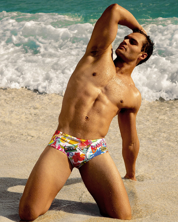 Male model at the beach wearing the PEOPLE FROM IBIZA Swim Brief in a pop color with the Miami pop art by BANG! Clothes