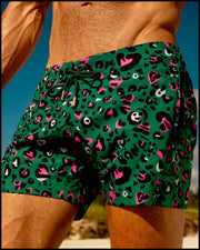 Male model at the beach wearing the CAMO CHAMELEON Flex Shorts. Inspired by pink and black animal print by BANG! Clothes the official brand of men’s swimwear. 