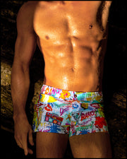 Male model wearing the PEOPLE FROM IBIZA Mini Shorts featuring a colorful Miami-inspired artwork by BANG! Clothes the official brand of men’s swimwear brand based in Miami, FL.