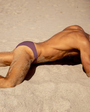 The BUST A MAUVE swimwear series by BANG! Miami, featuring light mauve purple color in all men's swimsuit silhouettes.