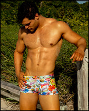 Male model wearing the PEOPLE FROM IBIZA Swim Trunks in a multi-color Miami inspired theme by BANG! Clothes the official brand of men’s swimwear brand based in Miami, FL.