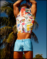 View of a male model at the beach wearing the MAGNET BLUE Mini Shorts and the PEOPLE FROM IBIZA Cotton Tank Top made by the Bang! Miami’s official brand of men's swimwear.