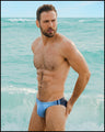 Male model at the beach wearing the CASINO ROYALE (BLUE) Swim Mini Brief. This Summer swim brief swimsuit for the beach with a stylish color block design in dark blue for men. This high-quality swimwear item is by BANG! Clothes, a men’s beachwear brand from Miami. Inspired by the iconic style of Daniel Craig's blue swim trunks in the 2006 film Casino Royale.