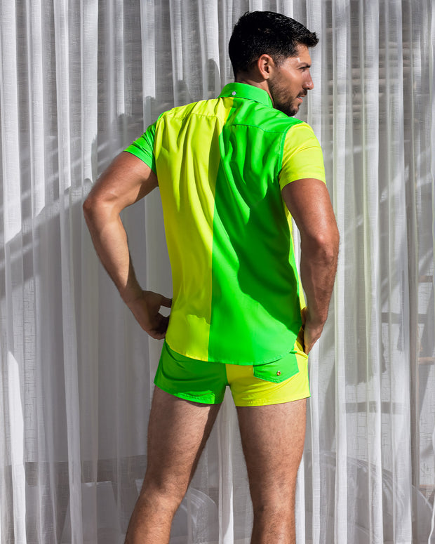 Model wearing the Single Bilingual (Neon Yellow/Green) beachwear set. The set consists of a comfortable, breathable Hawaiian stretch shirt in a neon color-block design, with matching show shorts.