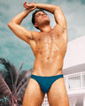 The new CHIC TEAL men 's beachwear series in blue and green color hues for Spring/Summer 2024 from the new DC2 capsule-brand by BANG! Miami  swimwear.