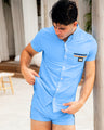 Male model wearing the COASTAL BLUE Mini Shorts and matching Stretch Shirt by DC2, a Miami-based brand. These are light blue with two stripes on the side. One stripe is bright orange, while the other is navy.