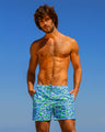 Model wearing DC2 Miami CAMO POP (BLUE/GREEN) Resort Shorts in blue and green, featuring a tropical camouflage pattern perfect for beach or resort wear.