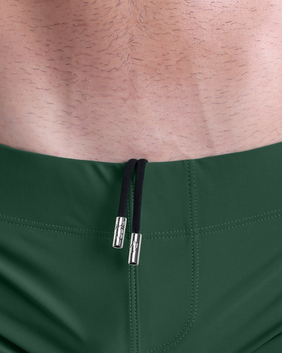 Close-up view of men’s summer beach shorts by DC2 clothing brand, showing black cord with custom branded metallic silver cord ends.
