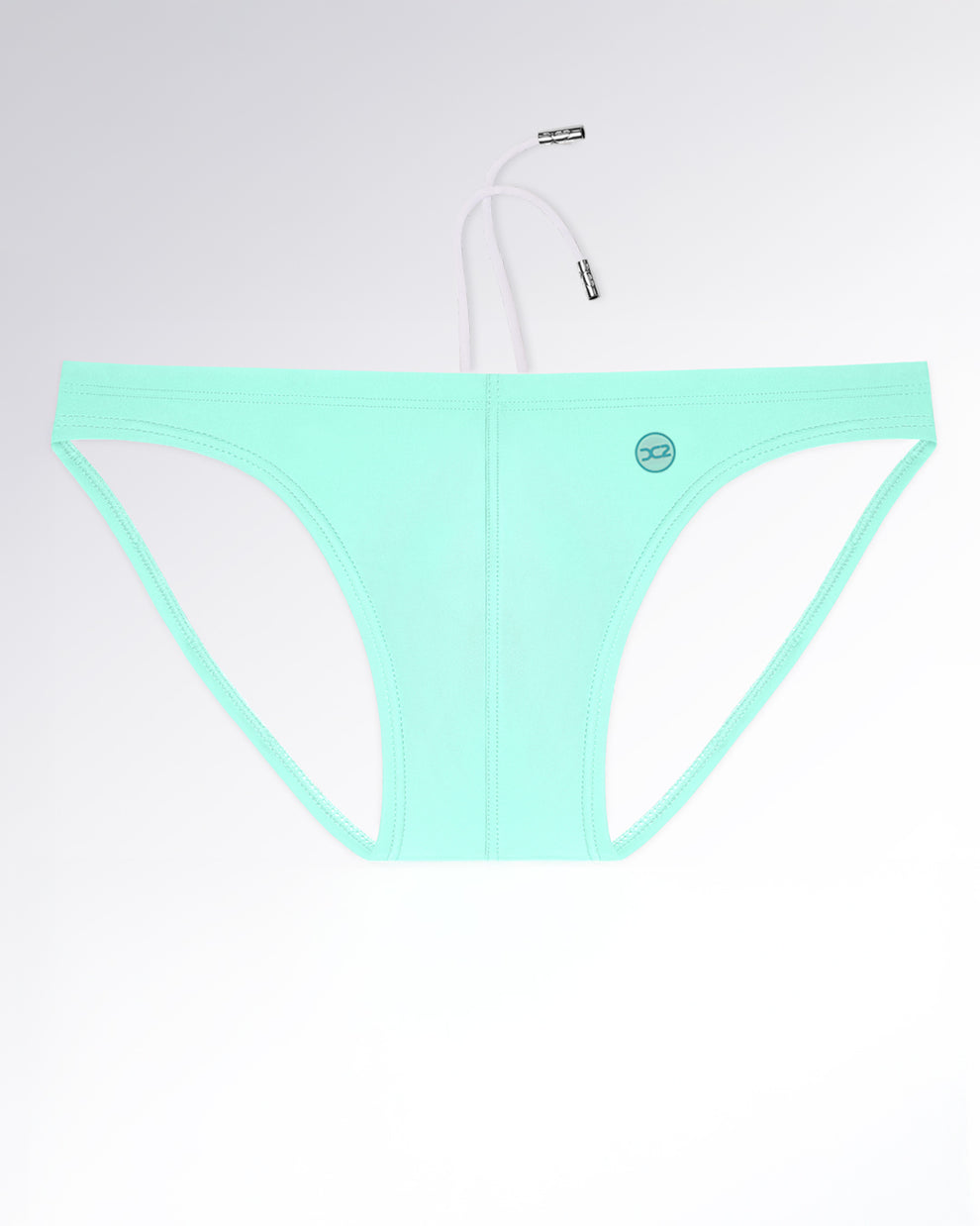 Model wearing AQUA LITE swim mini briefs for men in a smooth, solid seafoam mint color. Sleek and modern men’s swimwear with a minimal silhouette that celebrates clean lines and understated summer freshness.