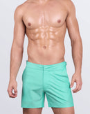 DC2 AQUA LITE — model wearing Tailored Shorts in Aqua Lite, featuring a sleek silhouette and vibrant pastel green shade.