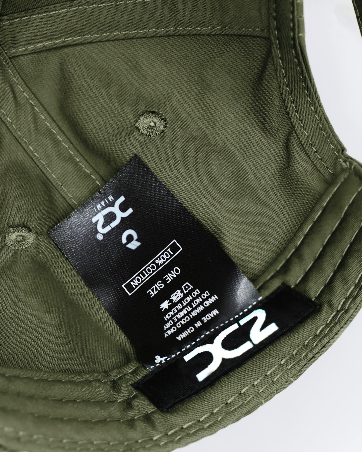 Interior view of the DC2 Army Green Resort Cap — showing soft cotton lining, branded label, and adjustable construction.