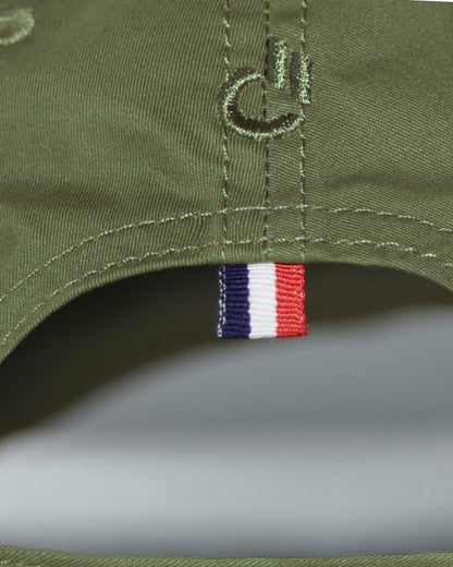 Back detail of the DC2 Resort Cap in Army Green — featuring tonal stitching and a woven tricolor accent tab.