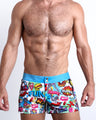 Front view of model wearing the BANG ONE men’swim bottoms  features fun and energetic comics-style graphics in bold colors, with a BANG! illustration by the Bang! Clothes brand of men's beachwear from Miami.