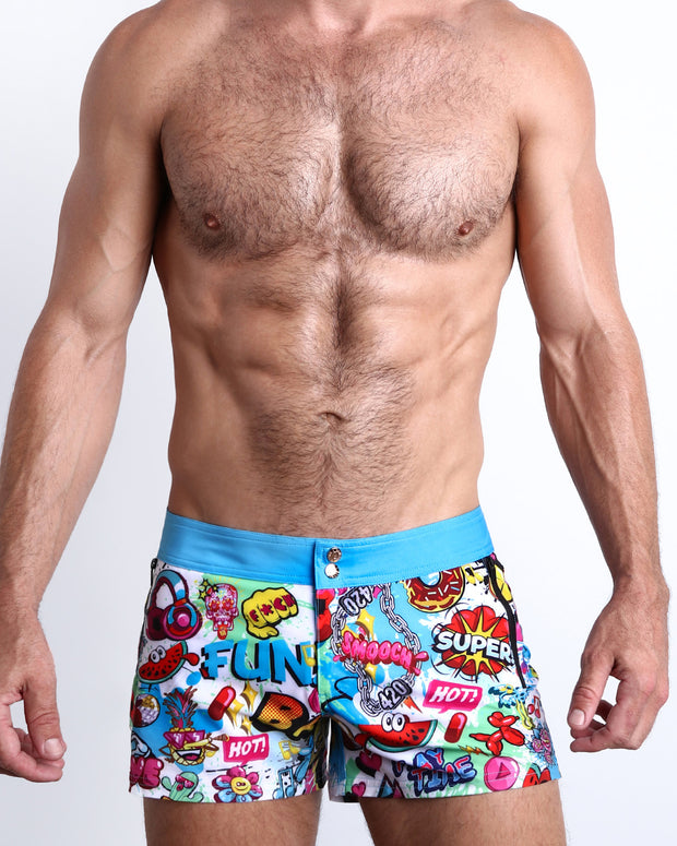 Front view of model wearing the BANG ONE men’swim bottoms  features fun and energetic comics-style graphics in bold colors, with a BANG! illustration by the Bang! Clothes brand of men&