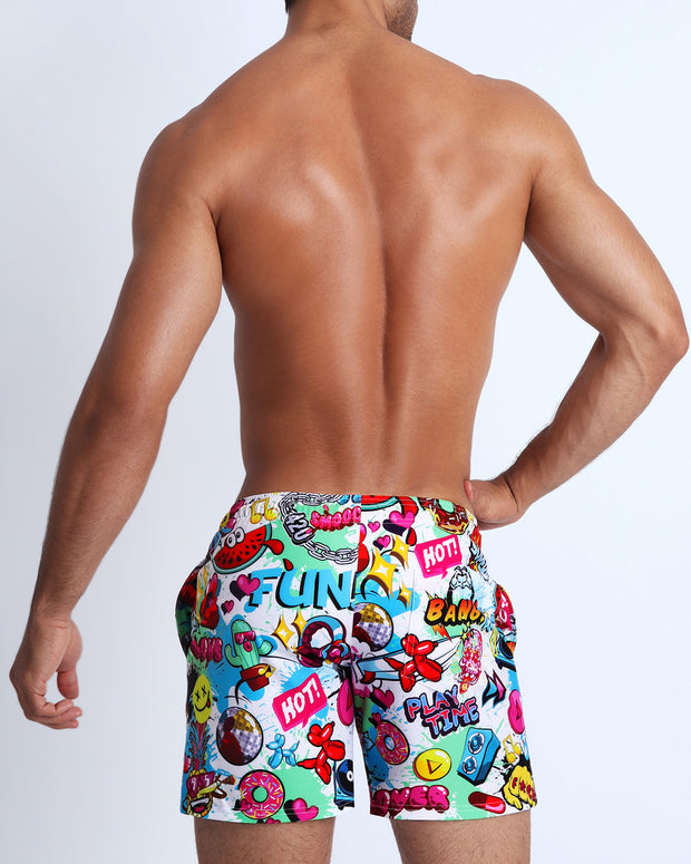 Back side of the BANG ONE beach mens Resort Shorts swimsuit features fun and energetic comics-style graphics in bold colors, with a BANG! illustration by BANG! Clothes in Miami.