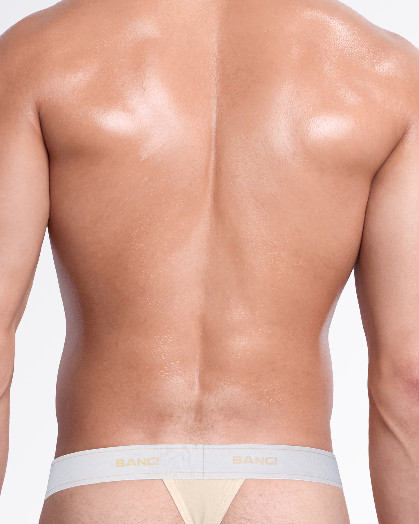 Back view of the Bare Beige men’s cotton modal thong, showing its minimal-coverage silhouette and branded elastic waistband.