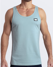 Frontal view of male model wearing the BARELY TEAL in a solid light teal color casual gym tank top for men by the DC2 brand of men's beachwear from Miami.