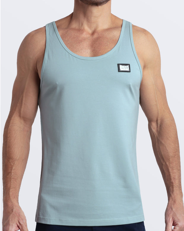 Frontal view of male model wearing the BARELY TEAL in a solid light teal color casual gym tank top for men by the DC2 brand of men&