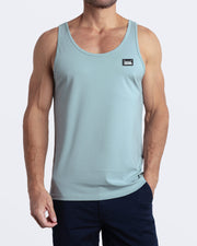 A model wearing the BARELY TEAL men's fitness breathable tank top with the BLOOMING BLUE Street Shorts. The casual beach tank top is made of modal cotton blend in a light teal green color by DC2 Miami menswear.