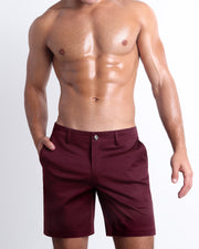 Front view of a male model wearing BEAU BERRY men's chino shorts in a solid red color with reversible cuffs by DC2 a BANG! Miami Clothes capsule brand.