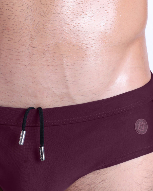 Close-up view of the BERRY GOOD men’s drawstring briefs showing black cord with custom branded metallic silver cord ends, and matching custom eyelet trims in silver.