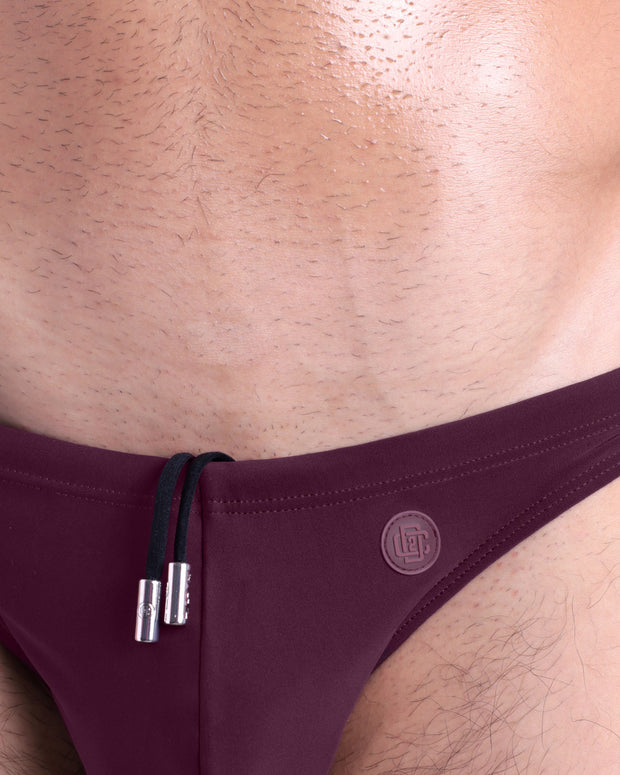 Close-up view of the BERRY GOOD men’s drawstring briefs showing black cord with custom branded metallic silver cord ends, and matching custom eyelet trims in silver.