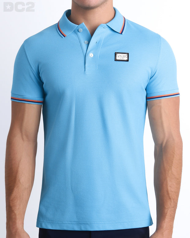 Front view of the BISCAYNE LIGHT BLUE Polo Shirt. It features a slim fit and short sleeves for a modern twist. Made from Peru&