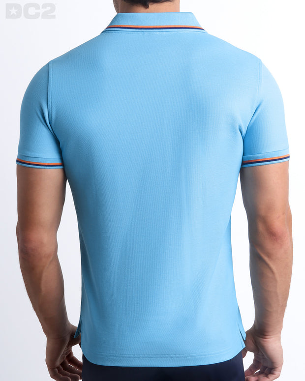 Back View of the BISCAYNE LIGHT BLUE Premium Cotton Polo Shirt for Men in solid light blue with orange and navy blue stripes on ribbed-knit collar and cuffs. The short-sleeve classic polo shirt is designed by DC2 in Miami.