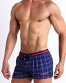 Side view of men’s BJORN AGAIN (FULL BLUE) shorter leg length shorts with dual pockets for men in navy blue with white stripes made by Miami based Bang brand of men's beachwear.