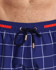 Close-up view of the BJORN AGAIN (FULL BLUE) men’s summer shorts, showing dark blue cord with custom branded golden cord ends, and matching custom eyelet trims in gold.