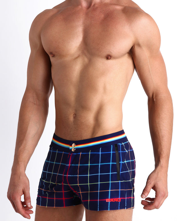 Side view of men’s Summer swimsuit in BJORN THIS WAY (DARK) in navy with rainbow color stripes inspired iconic P.L. Rolando&